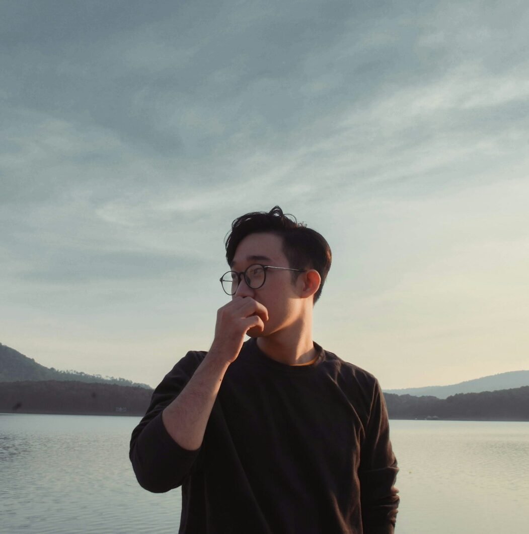 woman in brown long sleeve shirt wearing black framed eyeglasses